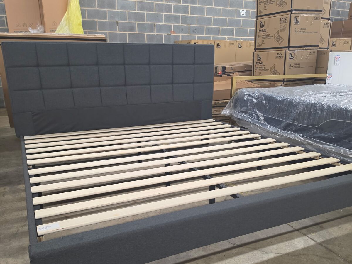 An upholstered platform bed frame in charcoal.