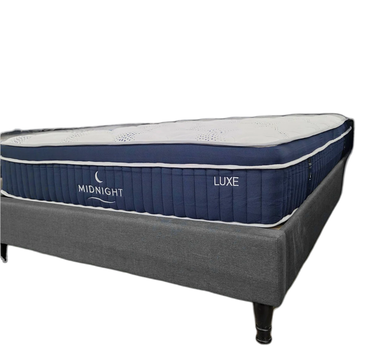 The Midnight Luxe mattress on its base, cut out: a navy border with white piping.